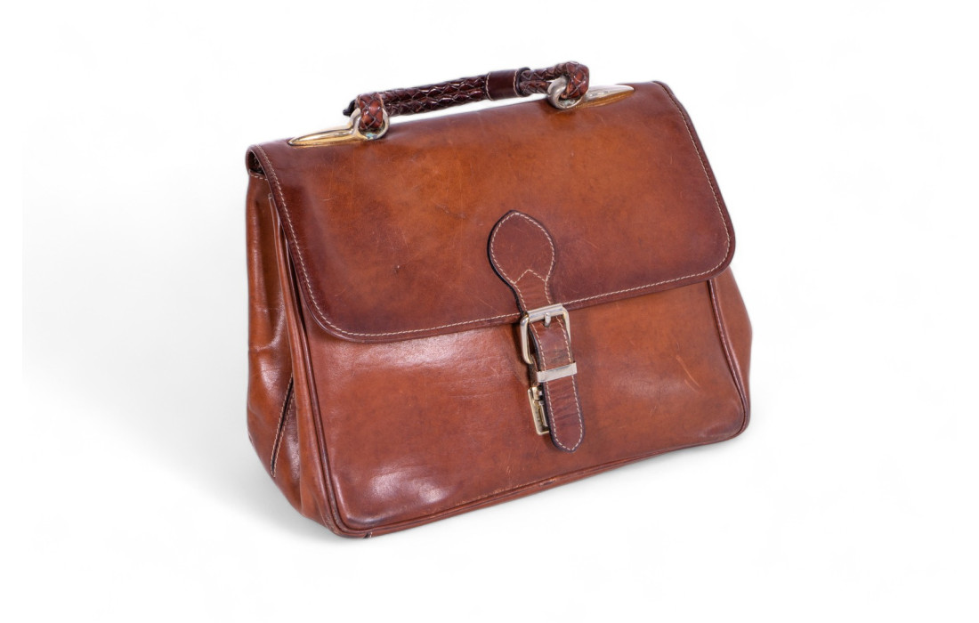 Leather bag with belt closure.